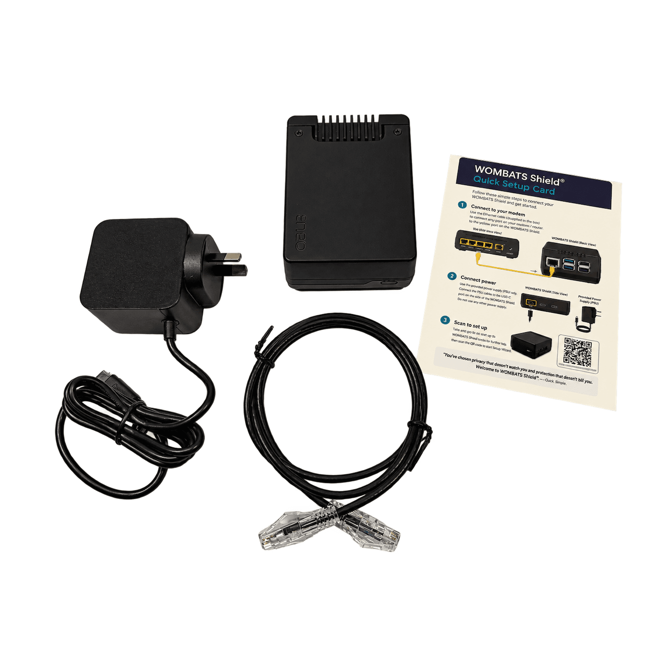 Laid out on white: a Shield, its power supply with an Australian plug, an Ethernet cable and the WOMBATS Shield quick setup card.
